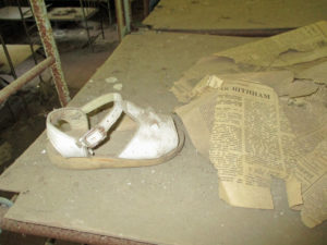 Abandoned shoes and relics of a once safe and happy life